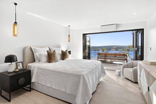 Modern bedroom with ocean view and outdoor seating