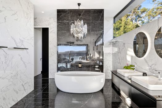 Luxurious marble bathroom with freestanding bathtub.