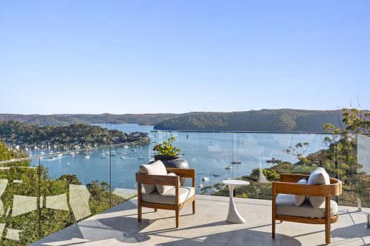 Scenic balcony view of river and hills.