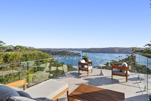 Scenic balcony view over bay with yachts.