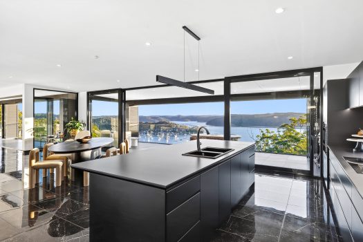 Modern kitchen with ocean view and black island